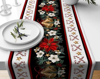 May include: A Christmas-themed table runner with a black central panel featuring red poinsettias, white flowers, gold bells, and stars. The runner has red and white borders with candy canes and gold stars.