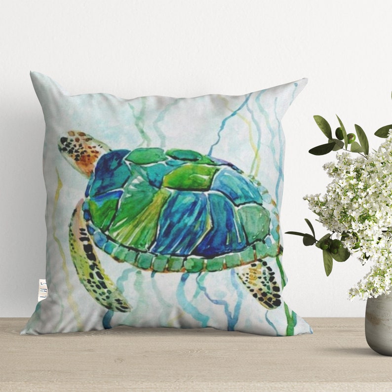 May include: A watercolor painting of a sea turtle swimming in the ocean. The turtle is green, blue, and brown with a white background. The turtle is surrounded by seaweed.