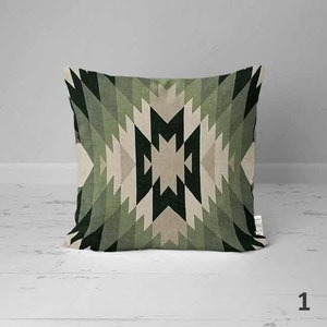 May include: A green, beige, and black geometric patterned throw pillow. The pattern is a repeating design of triangles and squares.