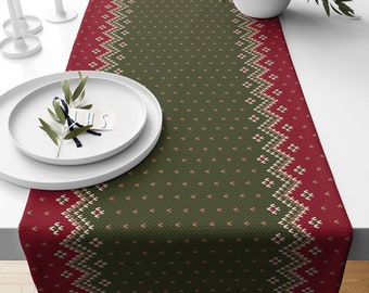 May include: A green and red table runner with a knitted pattern. The runner has a green background with a red and white geometric pattern along the edges.
