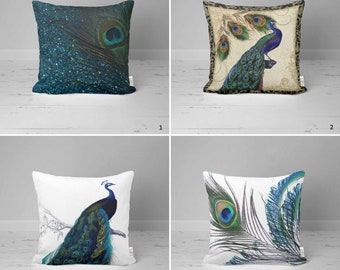 May include: Four decorative throw pillows with peacock designs. The pillows are white with blue, green, and gold accents. One pillow features a peacock feather, another has a peacock with its tail feathers spread, and the other two have a peacock with its tail feathers folded.