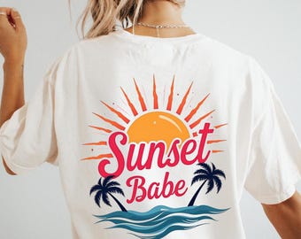 May include: White t-shirt with a graphic print of a sunset, palm trees, and the text "Sunset Babe".