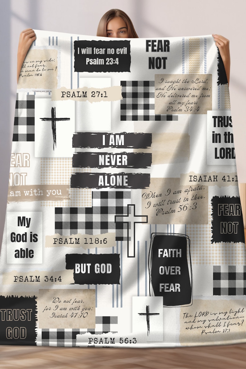 May include: A white and black checkered throw blanket with inspirational quotes and bible verses. The blanket features a black and white checkered pattern, a cross, and the words "Fear Not", "I Am Never Alone", "Trust God", "Faith Over Fear", and "But God".