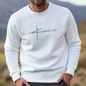 May include: White sweatshirt with a black graphic that says "I can't but I know a guy" with a diagonal line through the word "can't".
