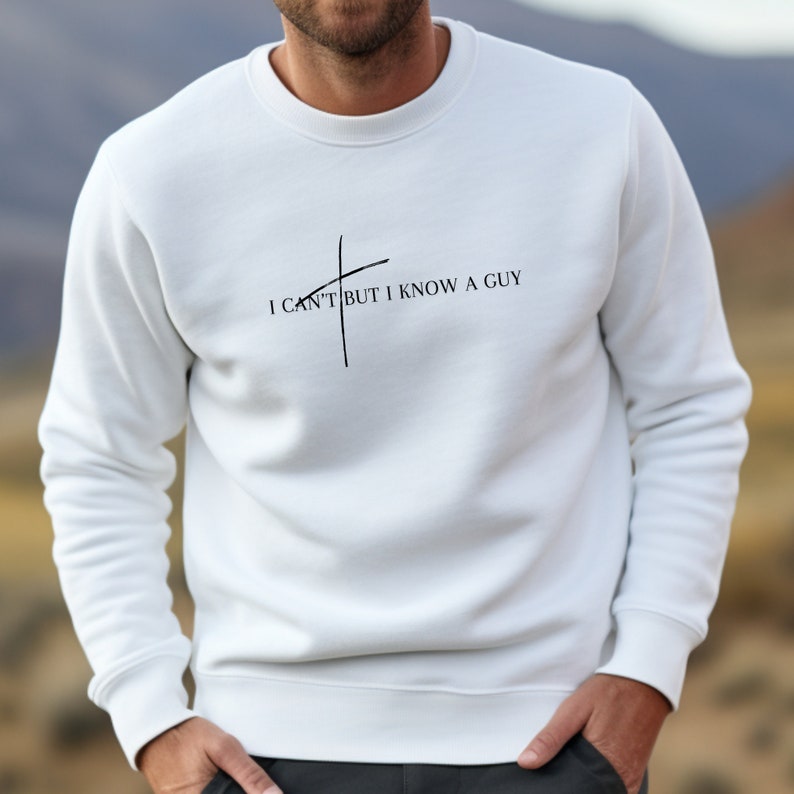 May include: White sweatshirt with a black graphic that says "I can't but I know a guy" with a diagonal line through the word "can't".