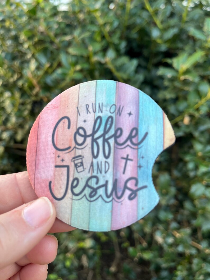May include: A round, colorful coaster with a rainbow design and the text "I run on coffee and Jesus".