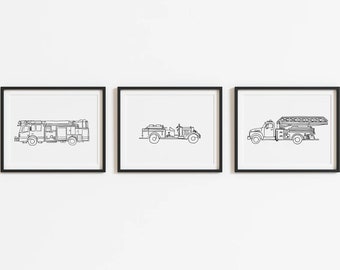 May include: Three black framed prints of line drawings of different fire trucks. The prints are hung on a white wall.