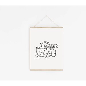 May include: A black and white line drawing of Mater, the tow truck character from the Disney Pixar movie Cars. The drawing is on a white background and is framed with a wooden frame.