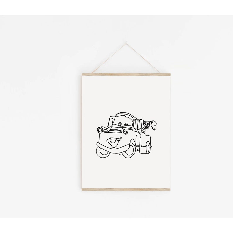 May include: A black and white line drawing of Mater, the tow truck character from the Disney Pixar movie Cars. The drawing is on a white background and is framed with a wooden frame.