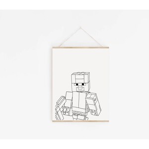 May include: Black and white line art print of a pixelated character, reminiscent of a popular video game. The artwork is framed in a light wood frame and hangs against a white wall. The character is depicted in a blocky, geometric style.