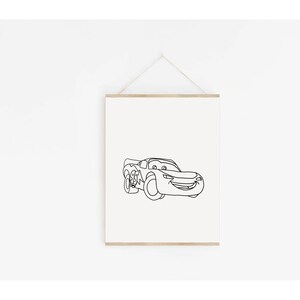 May include: A black and white line drawing of a cartoon race car with a smiling face. The car is facing forward and has large wheels. The drawing is on a white background.