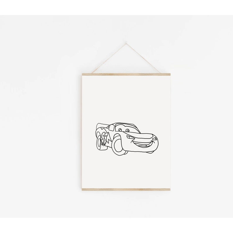 May include: A black and white line drawing of a cartoon race car with a smiling face. The car is facing forward and has large wheels. The drawing is on a white background.