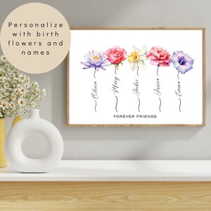 Puede incluir: Una impresi&oacute;n enmarcada con flores de acuarela y nombres, con el texto "Forever Friends". Las flores incluyen un loto morado, una rosa rosa, un narciso amarillo, un clavel rosa y una correhuela morada. Los nombres Olivia, Mary, Jackie, Jessica y Emma est&aacute;n escritos debajo.