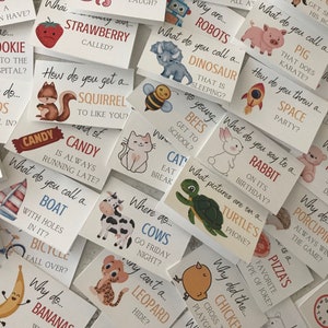 May include: A set of colourful cards with animal illustrations and riddles. Each card features a different animal, such as a squirrel, a cow, a turtle, a bee, a cat, a rabbit, a dinosaur, a robot, a pig, a leopard, a banana, a boat, a bicycle, a chicken, a pizza, and a porcupine. The cards are printed on white cardstock and have rounded corners.