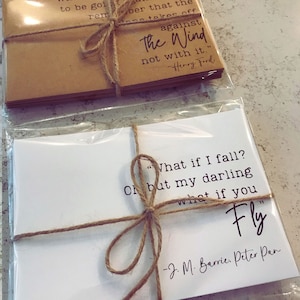 May include: Two sets of cards with inspirational quotes. The top set is brown with the quote "against the wind, not with it." by Henry Ford. The bottom set is white with the quote "What if I fall? Oh but my darling, what if you fly." by J.M. Barrie, Peter Pan.