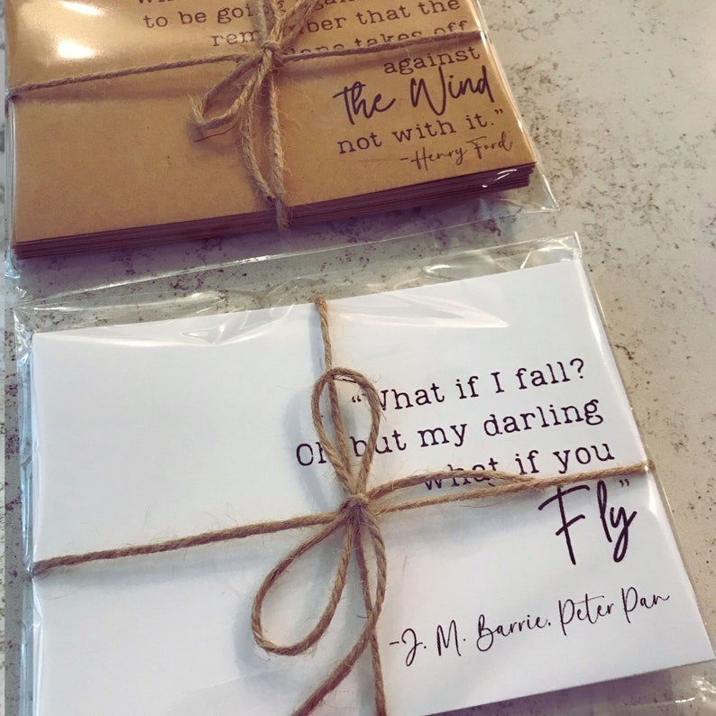 May include: Two sets of cards with inspirational quotes. The top set is brown with the quote "against the wind, not with it." by Henry Ford. The bottom set is white with the quote "What if I fall? Oh but my darling, what if you fly." by J.M. Barrie, Peter Pan.