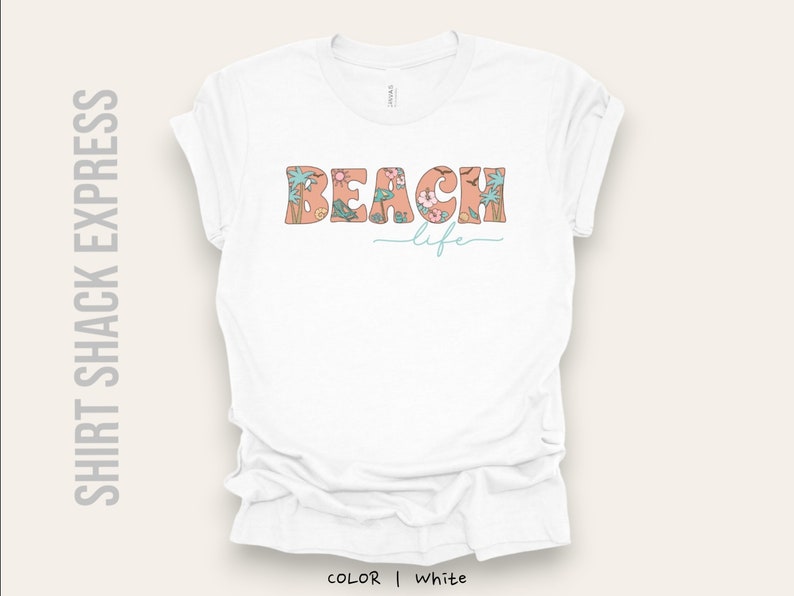 May include: White t-shirt with a floral design that spells out "Beach Life" in a retro font.