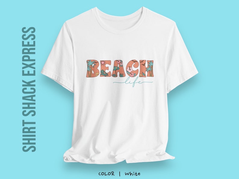 May include: White t-shirt with a floral design that spells out "Beach life" in orange letters.