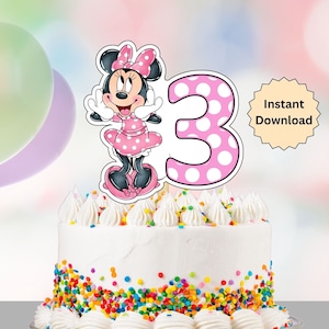 May include: A birthday cake with white frosting, colourful sprinkles, and a Minnie Mouse cake topper. The topper shows Minnie Mouse in a pink polka dot dress and a number 3 with pink polka dots. The words "Instant Download" are also visible.