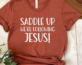 Saddle Up We're Following Jesus Shirt, Christian Cowgirl Tee, Western Faith Sweatshirt, Cowgirl Christian Gift, Country Church Shirt Women