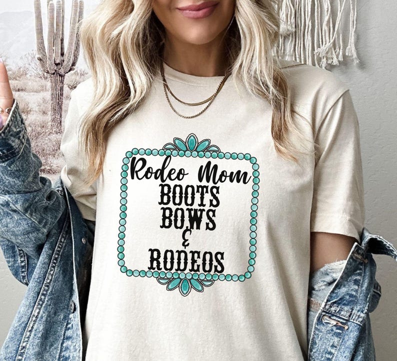 May include: A white t-shirt with a turquoise and black design that says "Rodeo Mom Boots Bows & Rodeos".