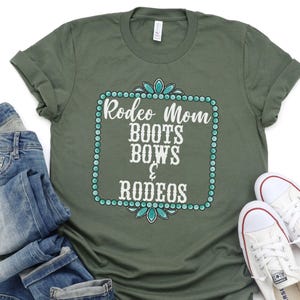 May include: Green t-shirt with a white graphic that says "Rodeo Mom Boots Bows & Rodeos" surrounded by turquoise jewels.
