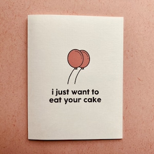 May include: A white card with a pink and brown illustration of two balloons and the text "i just want to eat your cake".
