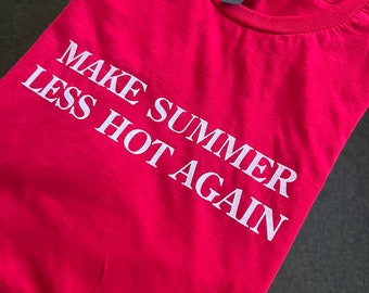 May include: Red t-shirt with white text that reads "MAKE SUMMER LESS HOT AGAIN".
