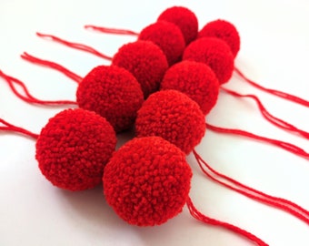Bright red hand made acrylic yarn pom poms available in 4cm, 5cm or 6cm diameter sizes (can also be made to order)