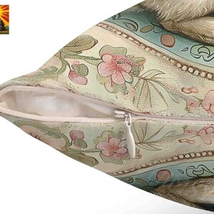 May include: A cream-colored pillow with a zipper closure. The pillow features a floral pattern with pink, green, and blue accents. The pattern includes stylized flowers, leaves, and vines. The pillow has a vintage aesthetic.