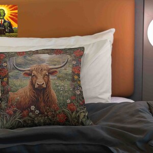 May include: A brown and white Highland cow stands in a field of wildflowers. The cow is surrounded by green grass and trees. The image is a close-up of the cow's head and neck.