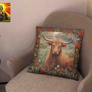 May include: A brown and white Highland cow with long horns stands in a field of green grass and wildflowers. The cow is surrounded by a border of red, white, and green flowers. The image is printed on a throw pillow.
