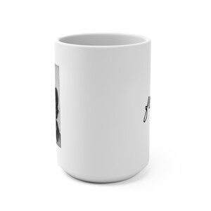 May include: A white ceramic mug featuring a black and white vertical rectangular graphic on the side. The graphic depicts a portrait of a person with dark hair. The word "grace" is printed in a black cursive script font on the mug surface.