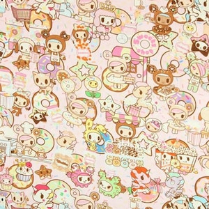 May include: A repeating pattern featuring cartoon characters, donuts, stars, and sweets in pink, brown, and white. The characters have bear and bunny ears, some holding donuts. The background is a light pink colour.