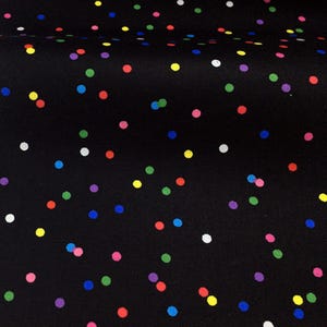 May include: A black fabric featuring a scattered pattern of small, solid-coloured polka dots in shades of red, blue, green, yellow, white, purple, and pink. The dots are distributed randomly across the dark surface, creating a vibrant, multi-coloured effect.