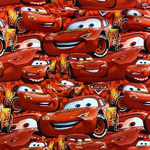May include: A repeating pattern of red cartoon race cars on a red and white checkered background. The cars have smiling faces, blue eyes, and the word "LIGHTYEAR" on the tires. The image is a fabric design.