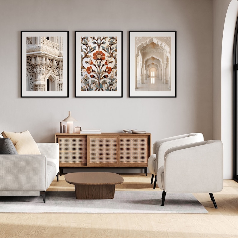 May include: Three framed prints of architectural details in a living room. The prints are black and white and feature intricate designs. The prints are hung on a white wall above a wooden cabinet and a coffee table.