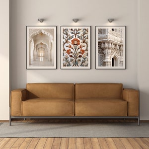 May include: Three framed prints of architectural details in a white and beige color scheme. The prints are hung on a white wall above a brown leather sofa.
