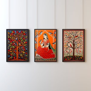 May include: Three framed paintings with a folk art style. The center painting features a woman in a red and green dress sitting on a patterned rug. The woman is holding a small bowl in her hands. The painting is set against a bright orange background. The paintings on either side feature trees with colorful leaves and birds.