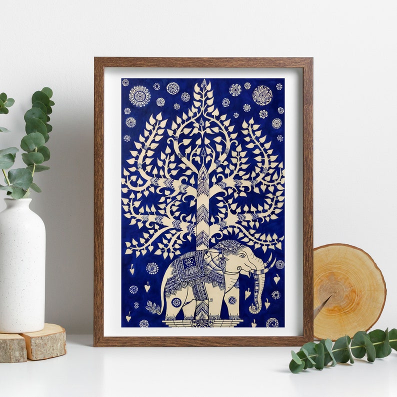 May include: A framed print of a white elephant standing under a white tree with blue leaves on a blue background. The tree is a traditional Thai design.