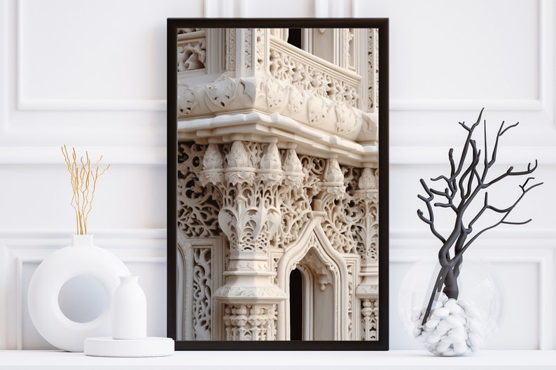 May include: A framed photograph of a white stone building with intricate carvings and a balcony. The building has a light beige color and the carvings are detailed and ornate.