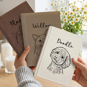 May include: Three hardback journals in brown, grey, and white, each featuring a custom line-art illustration of a pet and a name printed in black script. The journals are labelled Flash, Willow, and Doodle, with the brand name PETMADE in the corner.