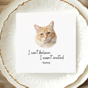 a white plate with a printed cat image and a handwritten message that reads "I can't believe I wasn't invited - Sunny".