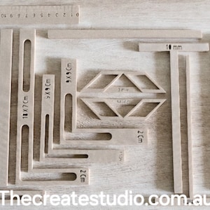May include: A set of wooden rulers and stencils for crafting projects. The rulers are marked in centimetres and the stencils are marked in centimetres and millimetres. Thecreatestudio.com.au is printed on the bottom of the image.