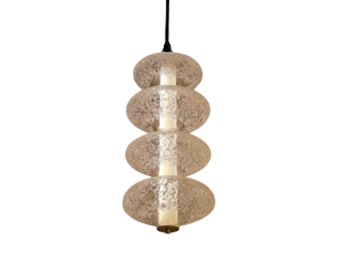 May include: A pendant light fixture with four stacked, round, frosted glass shades. The shades are slightly textured and have a subtle, iridescent quality.