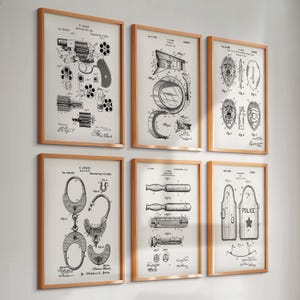 May include: Six framed patent prints featuring law enforcement equipment. The prints include detailed diagrams of a revolver, police hat, badges, handcuffs, a baton, and a riot shield. The frames are a light brown color, and the prints are in black and white.