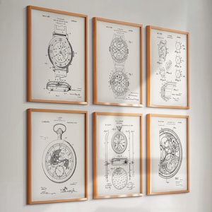 May include: Six framed vintage watch patent prints. Each print features detailed black and white technical drawings of different watch designs. The frames are a light brown color, and the prints are mounted on a neutral background.