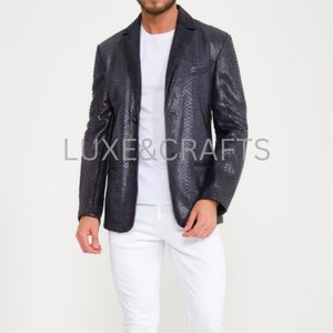 May include: A black snakeskin blazer with a classic two-button closure. The blazer has a subtle sheen and a textured pattern.