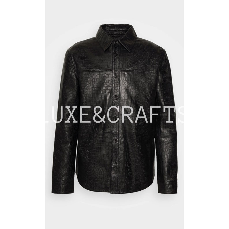 May include: A black leather shirt with a crocodile pattern. The shirt has a button-down collar and long sleeves.