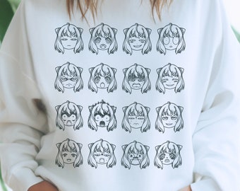 Pode incluir: Camisola branca com uma estampa gráfica em preto e branco de 18 rostos de estilo anime com diferentes expressões.
